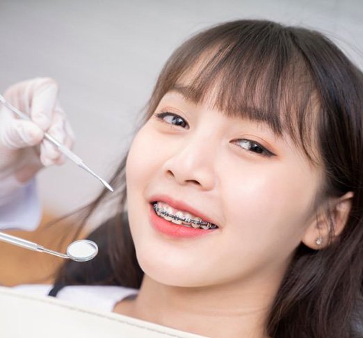 Close-up portrait of smiling dental patient with braces