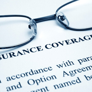 Glasses on a page of “Insurance Coverage Info” paragraph 1