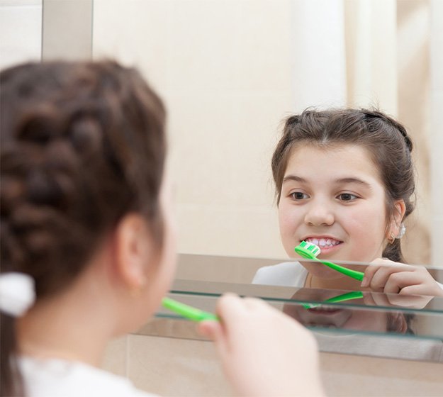 Female teenager cleaning her mouth in Plano   