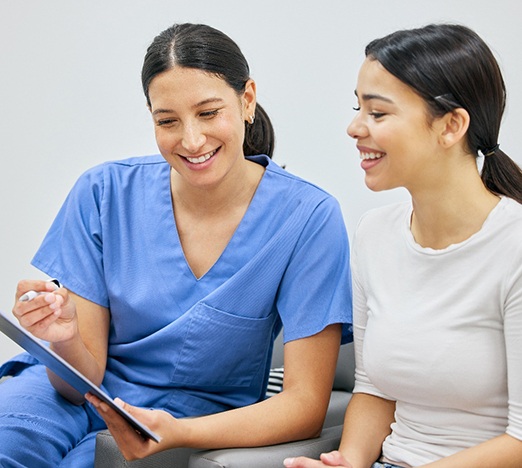 Dental receptionist talking with a patient