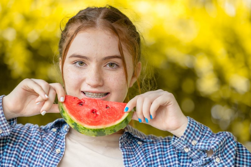Patient with braces eating watermelon